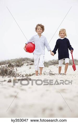 Siblings holding hands and walking View Large Photo Image Stock Photo - Siblings holding hands and walking. Fotosearch