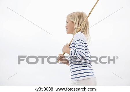 Side profile of a girl holding stick View Large Photo Image Stock Photo - Side profile of a girl holding stick. Fotosearch