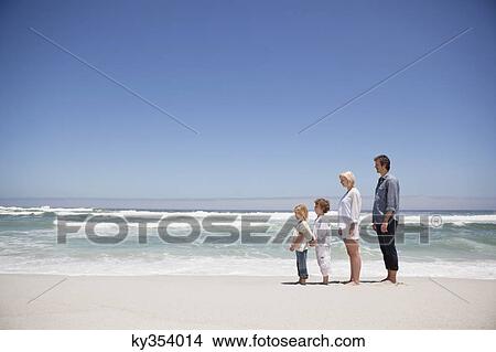Couple standing on the beach View Large Photo Image Picture - Couple standing on the beach. Fotosearch