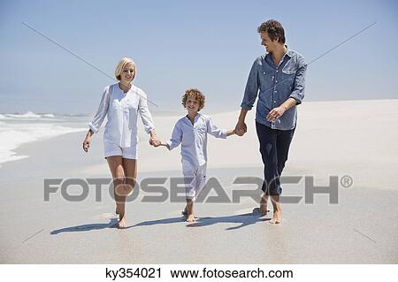 Couple walking on the beach with their son View Large Photo Image Stock Image - Couple walking on the beach with their son. Fotosearch