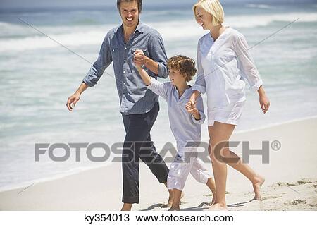 Couple with their son walking on the beach View Large Photo Image Stock Image - Couple with their son walking on the beach. Fotosearch