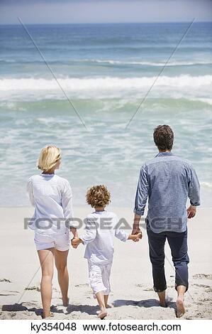 Couple with their son walking on the beach View Large Photo Image Stock Photo - Couple with their son walking on the beach. Fotosearch