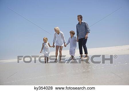 Stock Photo - Family enjoying on the beach. Fotosearch