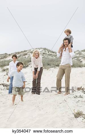 Family enjoying on the beach View Large Photo Image Stock Photo - Family enjoying on the beach. Fotosearch