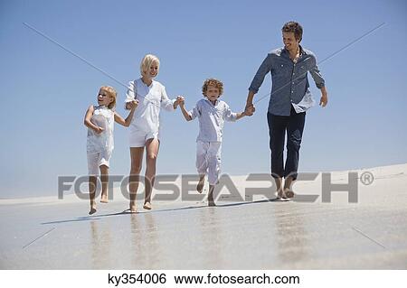 Stock Photograph - Family enjoying on the beach. Fotosearch