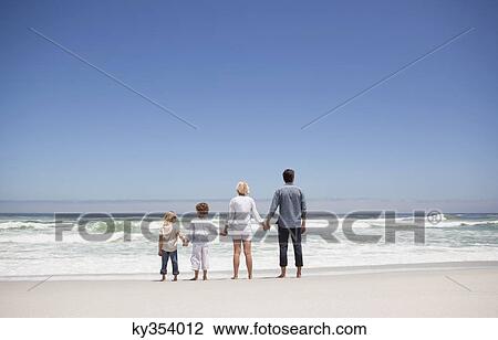 Family looking at sea view from beach View Large Photo Image Stock Image - Family looking at sea view from beach. Fotosearch