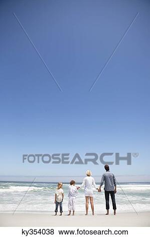 Family looking at sea view from beach View Large Photo Image Stock Photo - Family looking at sea view from beach. Fotosearch