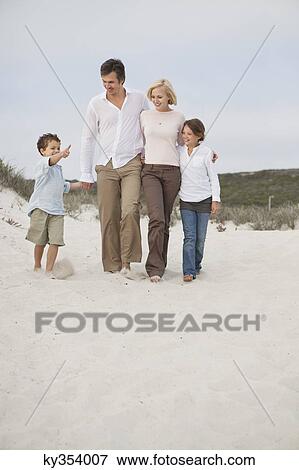 Family walking on the beach View Large Photo Image Stock Photo - Family walking on the beach. Fotosearch