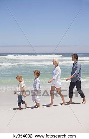 Stock Image - People walking on the beach. Fotosearch