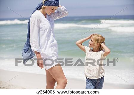 Woman with her daughter standing on the beach View Large Photo Image Stock Photography - Woman with her daughter standing on the beach. Fotosearch