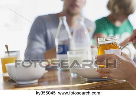 Family having breakfast at a dining table View Large Photo Image Stock Photography - Family having breakfast at a dining table. Fotosearch