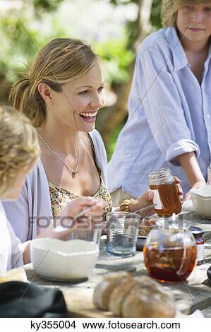 Family having food at front or back yard View Large Photo Image Picture - Family having food at front or back yard. Fotosearch