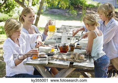 Family having food at front or back yard View Large Photo Image Stock Image - Family having food at front or back yard. Fotosearch