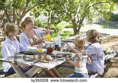 Family having food at front or back yard View Large Photo Image Stock Photo - Family having food at front or back yard. Fotosearch