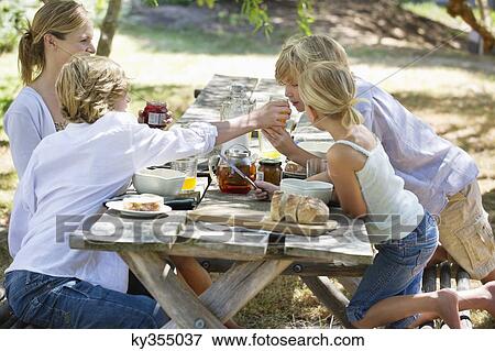 Family having food at front or back yard View Large Photo Image Stock Photo - Family having food at front or back yard. Fotosearch