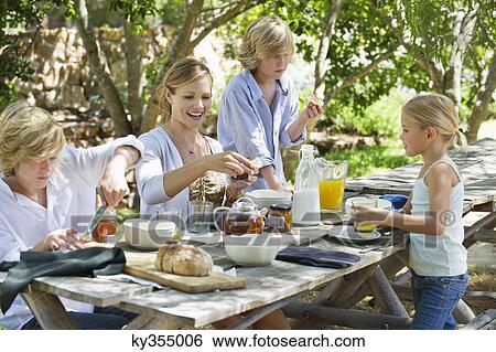 Family having food at front or back yard View Large Photo Image Stock Photograph - Family having food at front or back yard. Fotosearch