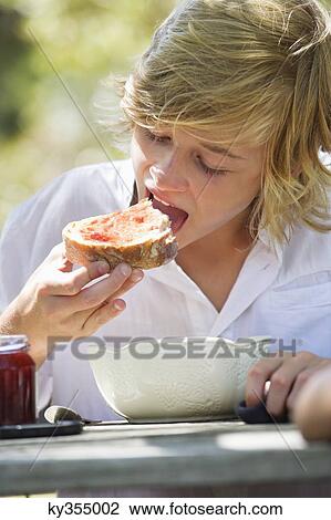 Little boy eating bread with jam outdoors View Large Photo Image Stock Image - Little boy eating bread with jam outdoors. Fotosearch