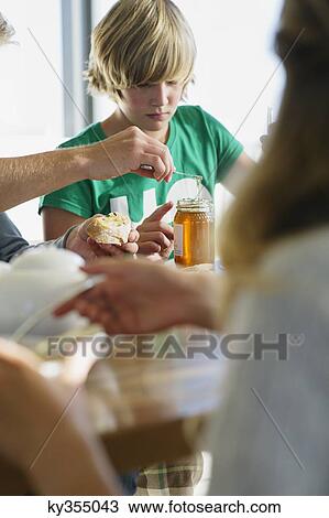 Teenage boy having breakfast with his parents View Large Photo Image Stock Image - Teenage boy having breakfast with his parents. Fotosearch