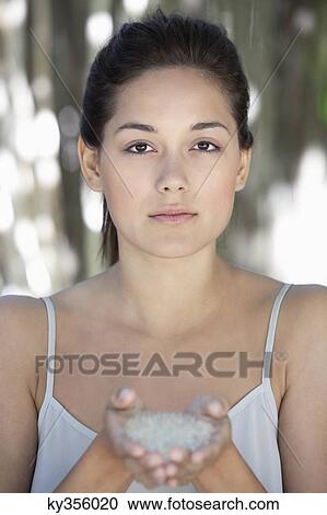 Portrait of a beautiful young woman holding bath salt in hand View Large Photo Image Stock Image - Portrait of a beautiful young woman holding bath salt in hand. Fotosearch