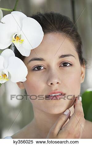 Portrait of a beautiful young woman with flowers View Large Photo Image Stock Photography - Portrait of a beautiful young woman with flowers. Fotosearch