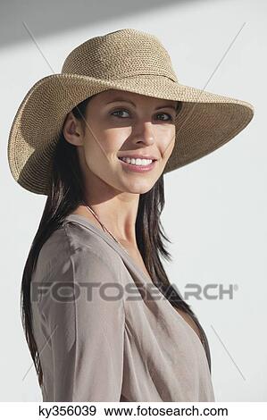Portrait of a woman wearing sun hat and smiling View Large Photo Image Stock Photo - Portrait of a woman wearing sun hat and smiling. Fotosearch