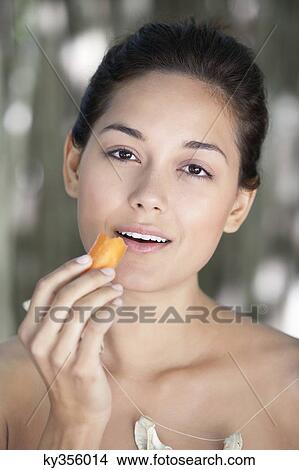 Portrait of a young woman eating a carrot View Large Photo Image Picture - Portrait of a young woman eating a carrot. Fotosearch