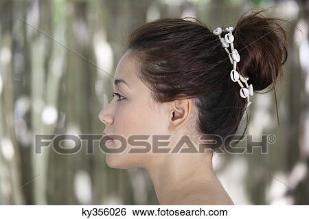 Side profile of a beautiful young woman View Large Photo Image Stock Photograph - Side profile of a beautiful young woman. Fotosearch