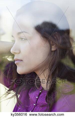 Young woman looking out of the window View Large Photo Image Stock Photograph - Young woman looking out of the window. Fotosearch