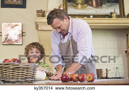 Cute little boy and his father kneading dough at kitchen View Large Photo Image Picture - Cute little boy and his father kneading dough at kitchen. Fotosearch