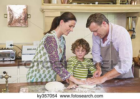 Cute little boy and his parents kneading dough at kitchen View Large Photo Image Picture - Cute little boy and his parents kneading dough at kitchen. Fotosearch