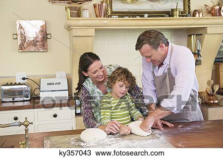 Cute little boy and his parents kneading dough at kitchen View Large Photo Image Stock Image - Cute little boy and his parents kneading dough at kitchen. Fotosearch
