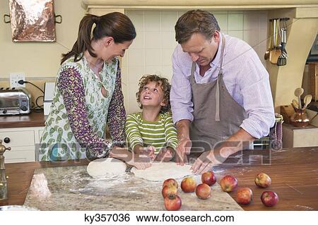 Cute little boy and his parents kneading dough at kitchen View Large Photo Image Stock Photograph - Cute little boy and his parents kneading dough at kitchen. Fotosearch