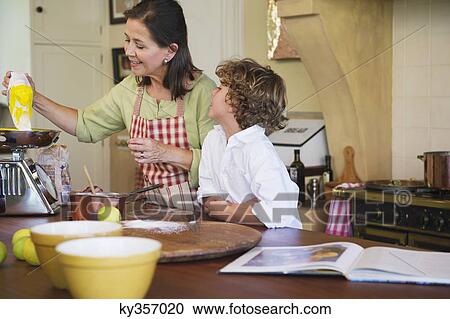 Grandmother and little boy cooking food at kitchen View Large Photo Image Stock Image - Grandmother and little boy cooking food at kitchen. Fotosearch
