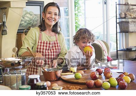 Grandmother and little boy cooking food at kitchen View Large Photo Image Stock Image - Grandmother and little boy cooking food at kitchen. Fotosearch