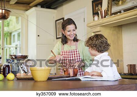 Grandmother and little boy cooking food at kitchen View Large Photo Image Stock Photo - Grandmother and little boy cooking food at kitchen. Fotosearch