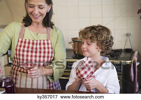 Grandmother and little boy cooking food at kitchen View Large Photo Image Stock Photo - Grandmother and little boy cooking food at kitchen. Fotosearch