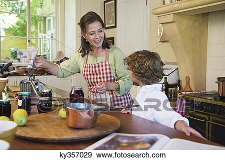 Grandmother and little boy cooking food at kitchen View Large Photo Image Stock Photo - Grandmother and little boy cooking food at kitchen. Fotosearch