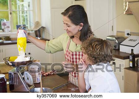 Grandmother and little boy cooking food at kitchen View Large Photo Image Stock Photo - Grandmother and little boy cooking food at kitchen. Fotosearch