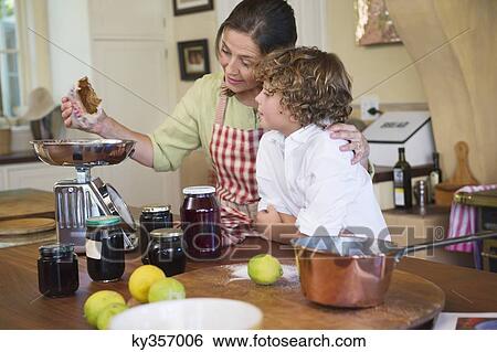 Grandmother and little boy cooking food at kitchen View Large Photo Image Stock Photograph - Grandmother and little boy cooking food at kitchen. Fotosearch