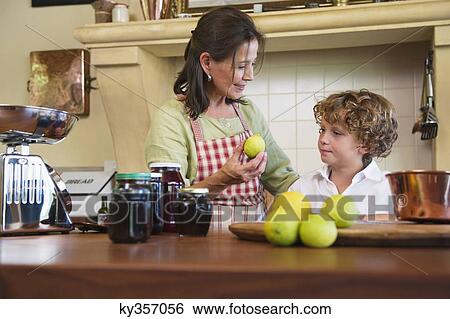 Grandmother and little boy cooking food at kitchen View Large Photo Image Stock Photograph - Grandmother and little boy cooking food at kitchen. Fotosearch
