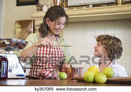 Grandmother and little boy cooking food at kitchen View Large Photo Image Stock Photography - Grandmother and little boy cooking food at kitchen. Fotosearch