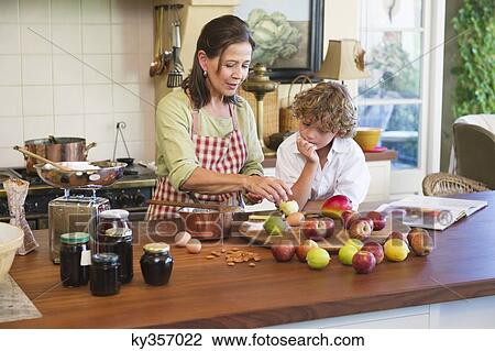 Grandmother and little boy peeling an apple at kitchen View Large Photo Image Stock Image - Grandmother and little boy peeling an apple at kitchen. Fotosearch