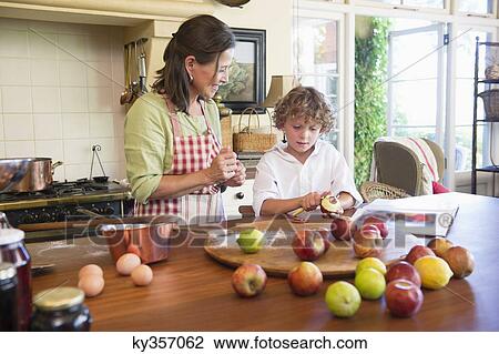 Grandmother and little boy peeling an apple at home View Large Photo Image Stock Image - Grandmother and little boy peeling an apple at home. Fotosearch