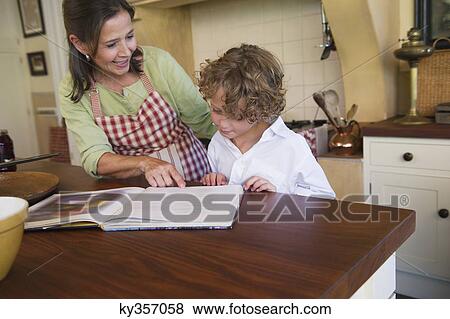 Grandmother and little boy reading recipe book View Large Photo Image Stock Photo - Grandmother and little boy reading recipe book. Fotosearch