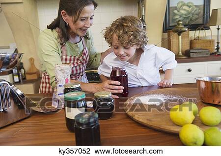 Grandmother and little boy smelling honey at kitchen View Large Photo Image Stock Image - Grandmother and little boy smelling honey at kitchen. Fotosearch