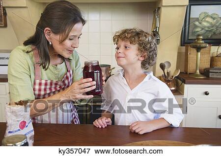 Grandmother and little boy smelling honey at kitchen View Large Photo Image Stock Photo - Grandmother and little boy smelling honey at kitchen. Fotosearch