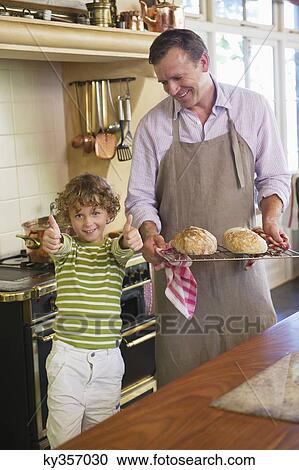 Little boy showing thumbs up sign with father holding baked breads View Large Photo Image Stock Image - Little boy showing thumbs up sign with father holding baked breads. Fotosearch