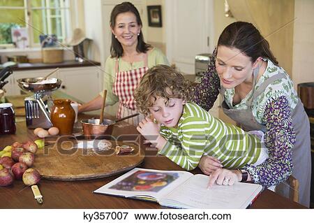 Multi generation family cooking food at kitchen View Large Photo Image Stock Photo - Multi generation family cooking food at kitchen. Fotosearch