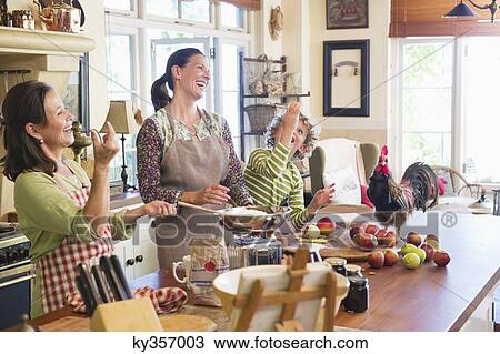 Multi generation family cooking food with chicken on kitchen counter View Large Photo Image Stock Image - Multi generation family cooking food with chicken on kitchen counter. Fotosearch
