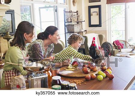 Multi generation family cooking food with chicken on kitchen counter View Large Photo Image Stock Photography - Multi generation family cooking food with chicken on kitchen counter. Fotosearch
